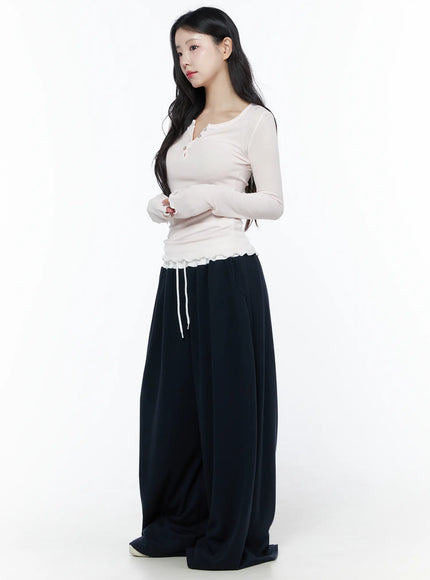 Color Contrast Wide-Leg Sweatpants IU525 Dark blue side view on model in cream long-sleeve top, relaxed wide-leg silhouette pooling at white sneakers