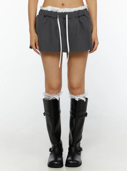 Contrast-Banded Low Rise Mini Skirt CL515 Dark gray front model shot from waist down with black knee-high boots lace socks highlighting full skirt shape