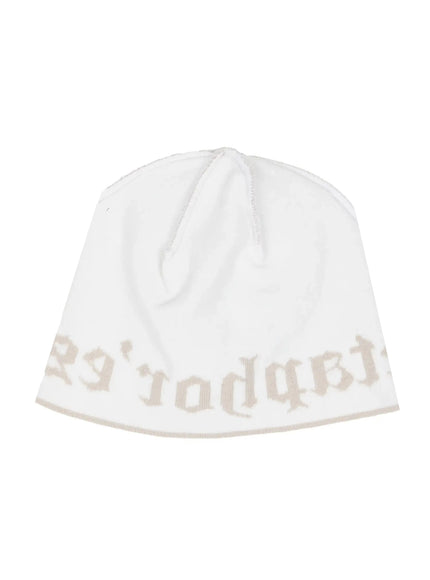 Contrast Graphic Text Reversible Beanie IL516 White product flat shot, reversible inside-out view with beige-tone gothic text on white knit fabric and crown seam detail