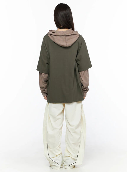 Contrast Piping Nylon Wide Pants CL523 Light beige back styling shot model in olive layered tee showing wide-leg silhouette and black piping