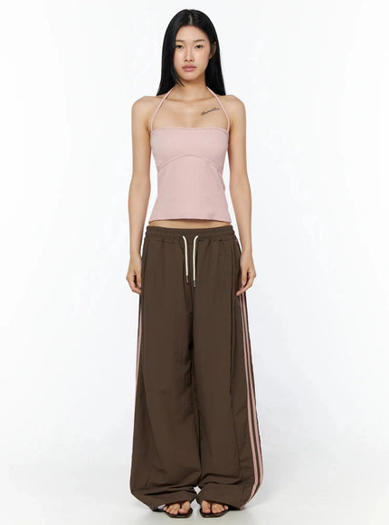Contrast Stripe Track Pants IL509 Brown full-length front shot on model standing straight in pink halter top, showcasing wide-leg silhouette and pink side stripes