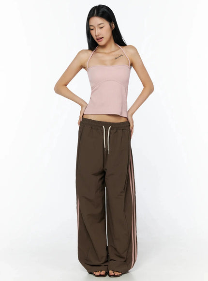 Contrast Stripe Track Pants IL509 Brown full-length front shot on model in pink halter top, wide-leg silhouette with pink double side stripes and cream drawstring