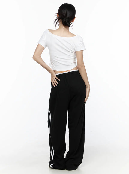 Contrast Stripe Wide Leg Sweatpants CL524 Black back full-body shot on model in white off-shoulder crop tee hand on hip showing back view of wide-leg silhouette and side stripes