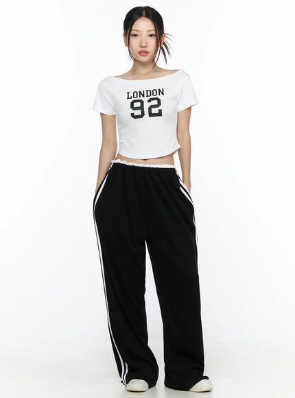 Contrast Stripe Wide Leg Sweatpants CL524 Black front full-body shot on model wearing white London 92 crop tee standing straight with hands in pockets and white sneakers