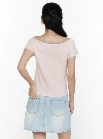 Contrast Trim Boat Neck Tee CL521 Light pink back shot on model showing clean back panel grey contrast boat neck trim and cropped length over denim skirt