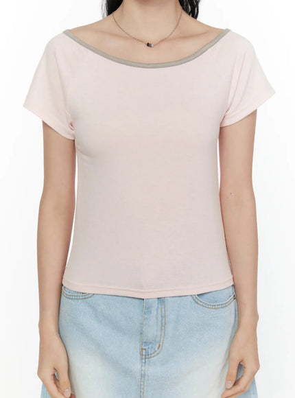 Contrast Trim Boat Neck Tee CL521 Light pink front close-up on model hand placed on chest showing grey rib-trim neckline detail and short sleeves