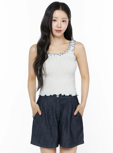 Contrast Trim Floral Tank Top IU525 Light beige front model shot hands in pockets arms relaxed showing scalloped hem and blue contrast trim with dark denim shorts