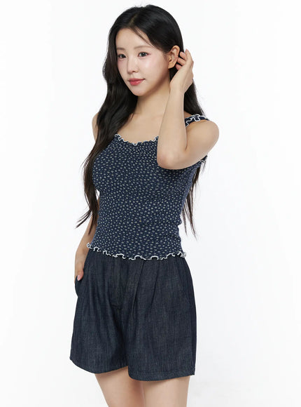 Contrast Trim Floral Tank Top IU525 Navy three-quarter side model shot hand raised to ear showcasing dark navy ditsy floral knit with white contrast ruffle trim