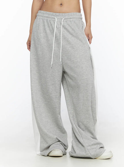 Contrast Wide-Leg Sweatpants CL528 Gray front view on model cropped at waist showing white drawstring elasticated waistband and side contrast panels with sneakers
