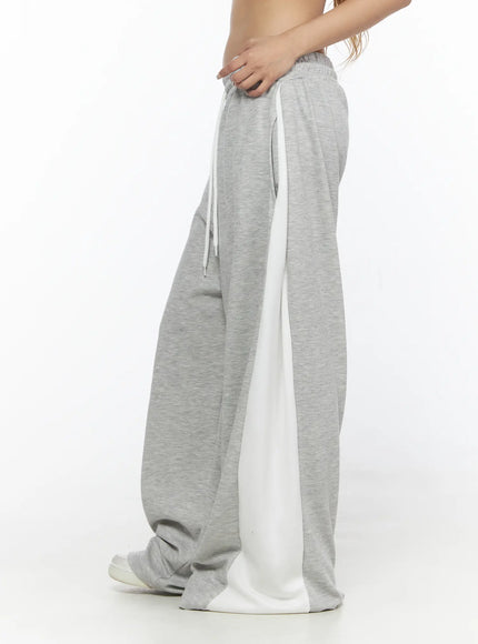 Contrast Wide-Leg Sweatpants CL528 Gray side view on model cropped at waist highlighting white contrast side panel elastic waistband and drawstring detail