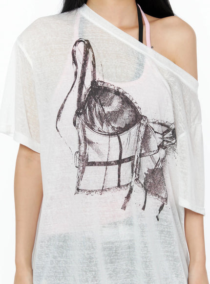 Corset Graphic Off-Shoulder Oversized Tee IL516 White close-up detail shot sheer fabric corset and garter belt sketch graphic off-shoulder neckline pink bralette layering