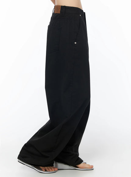 Cotton Balloon Pants IL502 Black side model shot without top, showing back pocket, brown leather brand patch on waistband and balloon leg silhouette