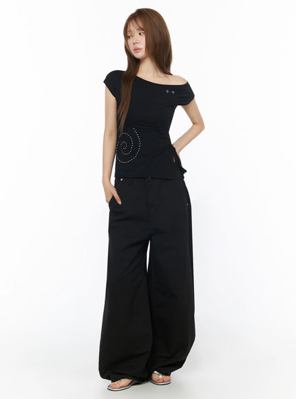 Cotton Balloon Pants IL502 Black three-quarter front view on model with hand in pocket, wide-leg silhouette showing full length with pooling hem