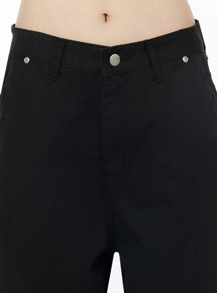 Cotton Balloon Pants IL502 Black close-up detail of waistband and front, showing V-shape low-rise waist, silver rivets and center button fastening
