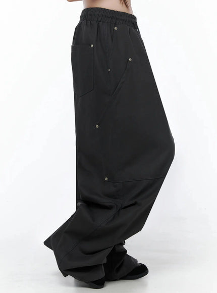 Cotton Carpenter Wide Pants IL502 Dark gray side view on model showing deep side pocket panel eyelets and voluminous hem pooling at floor