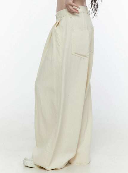 Cotton Wide Leg Pants IL521 Light beige side view on model showing back patch pocket, extreme wide-leg balloon silhouette, and gathered hem at ankle