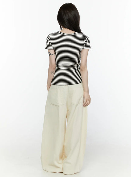 Cotton Wide Leg Pants IL521 Light beige full back view on model styled with striped top, showing double back pockets, wide-leg hem pooling at floor