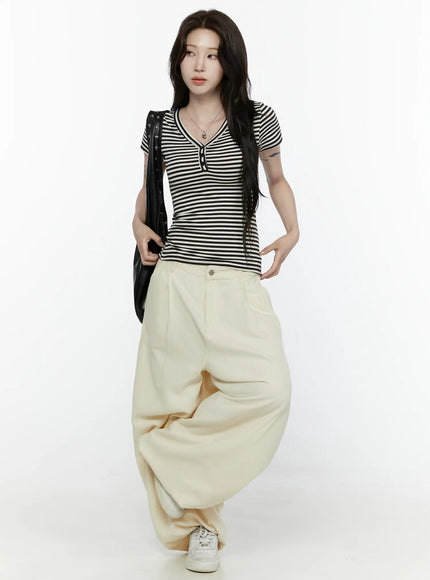 Cotton Wide Leg Pants IL521 Light beige full-body front styling shot on model paired with striped top, black shoulder bag, and white sneakers, relaxed wide-leg drape