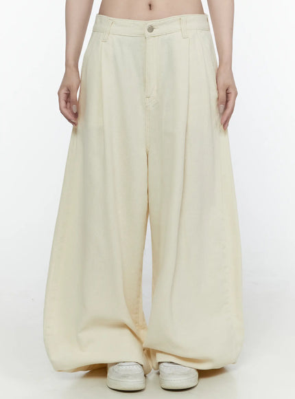 LEWKIN Cotton Wide Leg Pants IL521 Light beige front view on model wearing size S, pleated high-waist wide-leg silhouette with silver button, styled with white sneakers