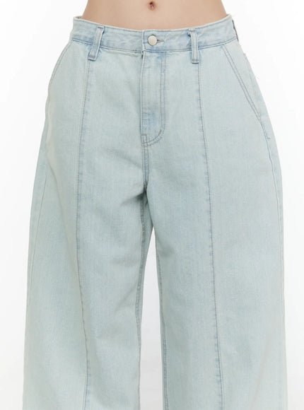 Cove Washed Wide Leg Jeans CL521 Light blue close-up front detail shot on model highlighting waistband, silver button closure, front patch pocket, and vertical seam stitching
