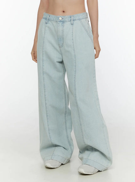 LEWKIN Cove Washed Wide Leg Jeans CL521 Light blue front close-up on model showing low-rise waistband, silver button, and front seam detail on wide leg denim