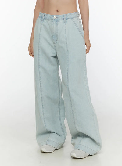 LEWKIN Cove Washed Wide Leg Jeans CL521 Light blue front close-up on model showing low-rise waistband, silver button, and front seam detail on wide leg denim