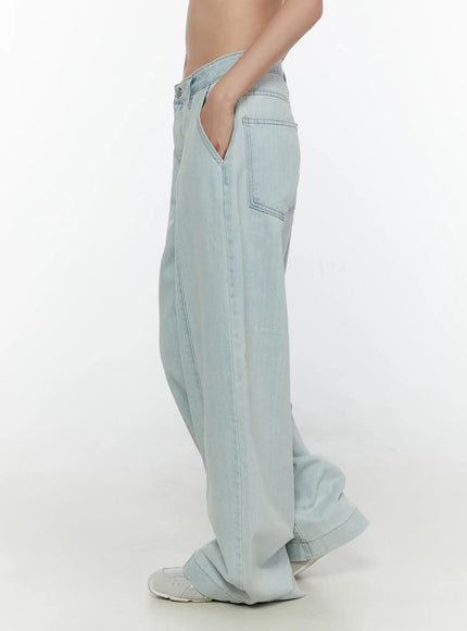 Cove Washed Wide Leg Jeans CL521 Light blue side view on model showing back patch pocket, wide leg silhouette, and vertical seam, hands in pockets, white sneakers