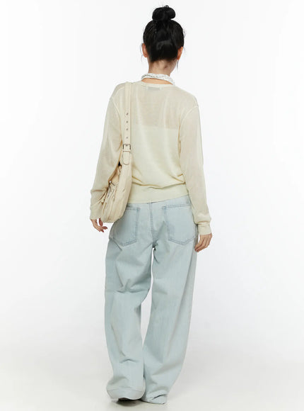 Cove Washed Wide Leg Jeans CL521 Light blue back full-length on model styled with cream sheer cardigan, lace top, shoulder bag, bun updo, white sneakers