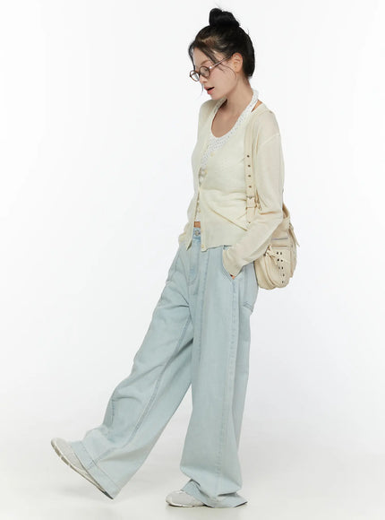Cove Washed Wide Leg Jeans CL521 Light blue side-angle full-length on model walking pose, styled with cream cardigan, lace top, shoulder bag, glasses, white sneakers