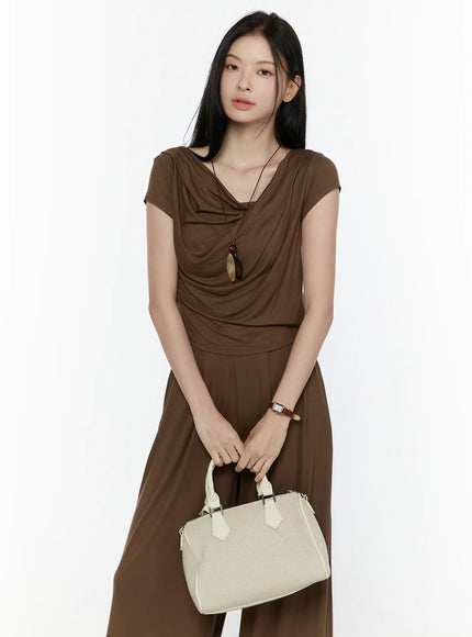 Cowl Neck Top and Loose-Fit Pants Set IL506 Brown front shot model holding cream bag with both hands necklace watch styling cowl top wide-leg pants