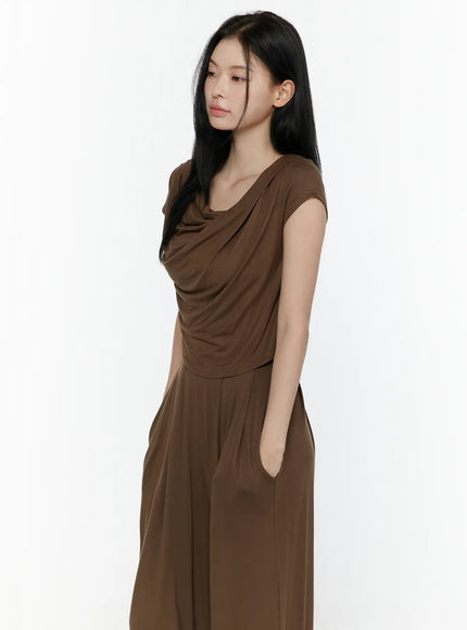Cowl Neck Top and Loose-Fit Pants Set IL506 Brown side shot model looking down hand in pocket holding cream bag cowl neck drape wide-leg pants