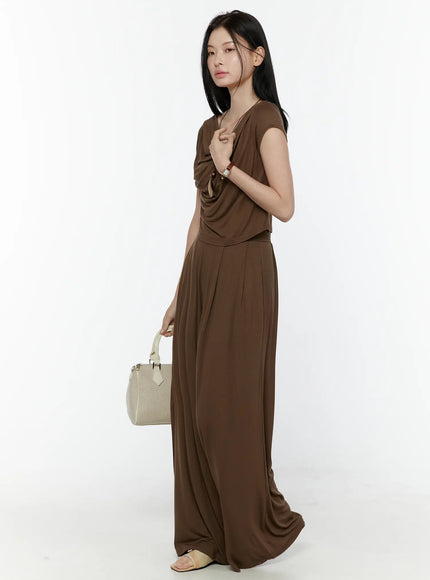 Cowl Neck Top and Loose-Fit Pants Set IL506 Brown side shot model touching neckline holding cream handbag watch necklace styling full length silhouette
