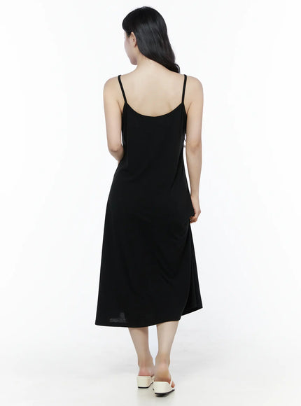 Criss-Cross Strap Maxi Dress IU525 Black back full-length view on model walking away, revealing open scoop back, spaghetti straps and midi hem with white mule sandals