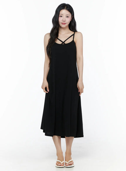 LEWKIN Criss-Cross Strap Maxi Dress IU525 Black S/M front view on model standing upright wearing white flip-flop sandals, flowy A-line midi silhouette