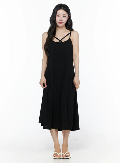 LEWKIN Criss-Cross Strap Maxi Dress IU525 Black S/M front view on model standing upright wearing white flip-flop sandals, flowy A-line midi silhouette