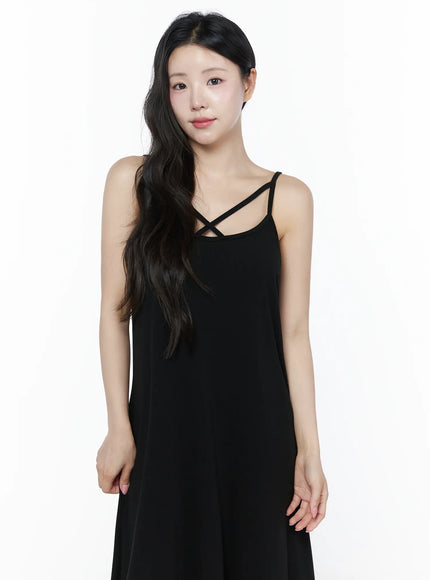 Criss-Cross Strap Maxi Dress IU525 Black upper-body front close-up on model showing criss-cross strap neckline detail and loose jersey bodice