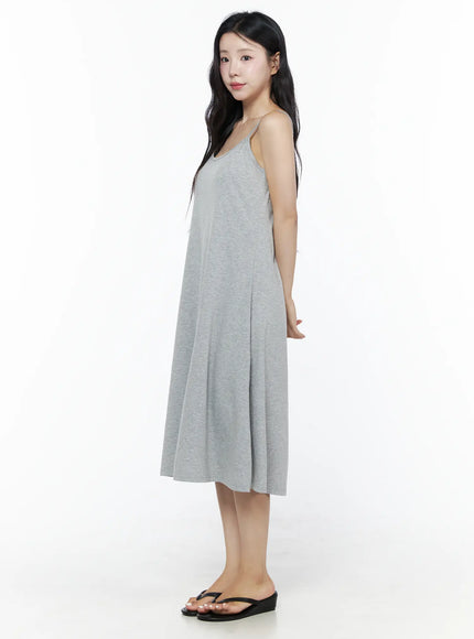 Criss-Cross Strap Maxi Dress IU525 Gray side view full-length on model showing heathered gray jersey fabric, A-line flare and spaghetti strap neckline with black sandals