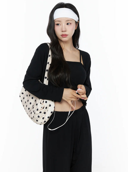 Crop Cami, Cardigan & Sweatpants Set IU525 Black side three-quarter shot on model holding polka dot shoulder bag and earphones, cropped cardigan layered over square-neck cami