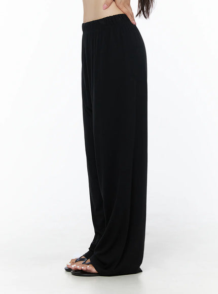 Crop Cami, Cardigan & Sweatpants Set IU525 Black side shot on model showing elastic waistband and fluid wide-leg silhouette of sweatpants with thong sandals