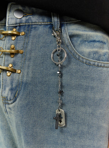 Cross Charm Tag Keychain IL507 Silver detail close-up clipped to denim waistband showing silver lobster clasp, black cross charm, hematite beads, and cutout dog tag
