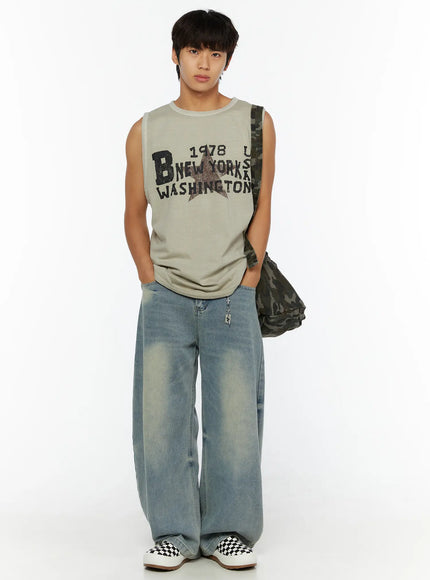 Cross Charm Tag Keychain IL507 Silver styled on male model full front view with graphic sleeveless tee and wide-leg jeans paired with camo bag and checkered sneakers