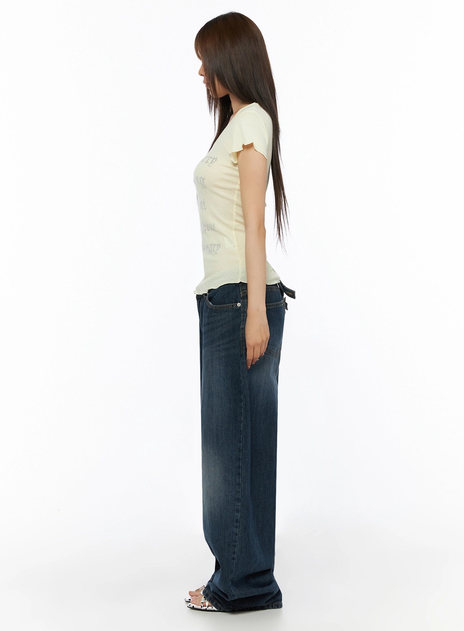 Cruz Wide Leg Jeans IL523 Dark blue side view on model, styled with yellow graphic tee, showcasing low-rise fit, extreme wide-leg silhouette, crossover back tab visible
