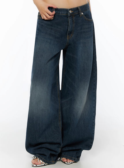 Cruz Wide Leg Jeans IL523 Dark blue front model shot from waist down, hand gripping pocket, oversized wide leg with pooled hem, polka-dot sandals visible