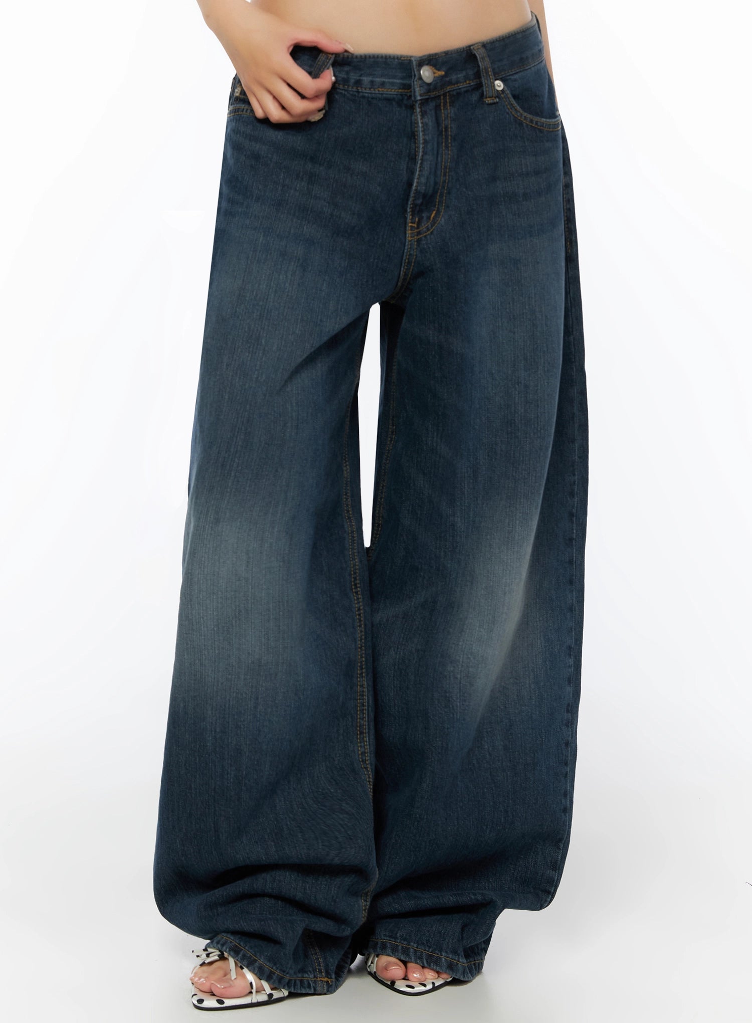 Cruz Wide Leg Jeans IL523 Dark blue front model shot from waist down, hand gripping pocket, oversized wide leg with pooled hem, polka-dot sandals visible