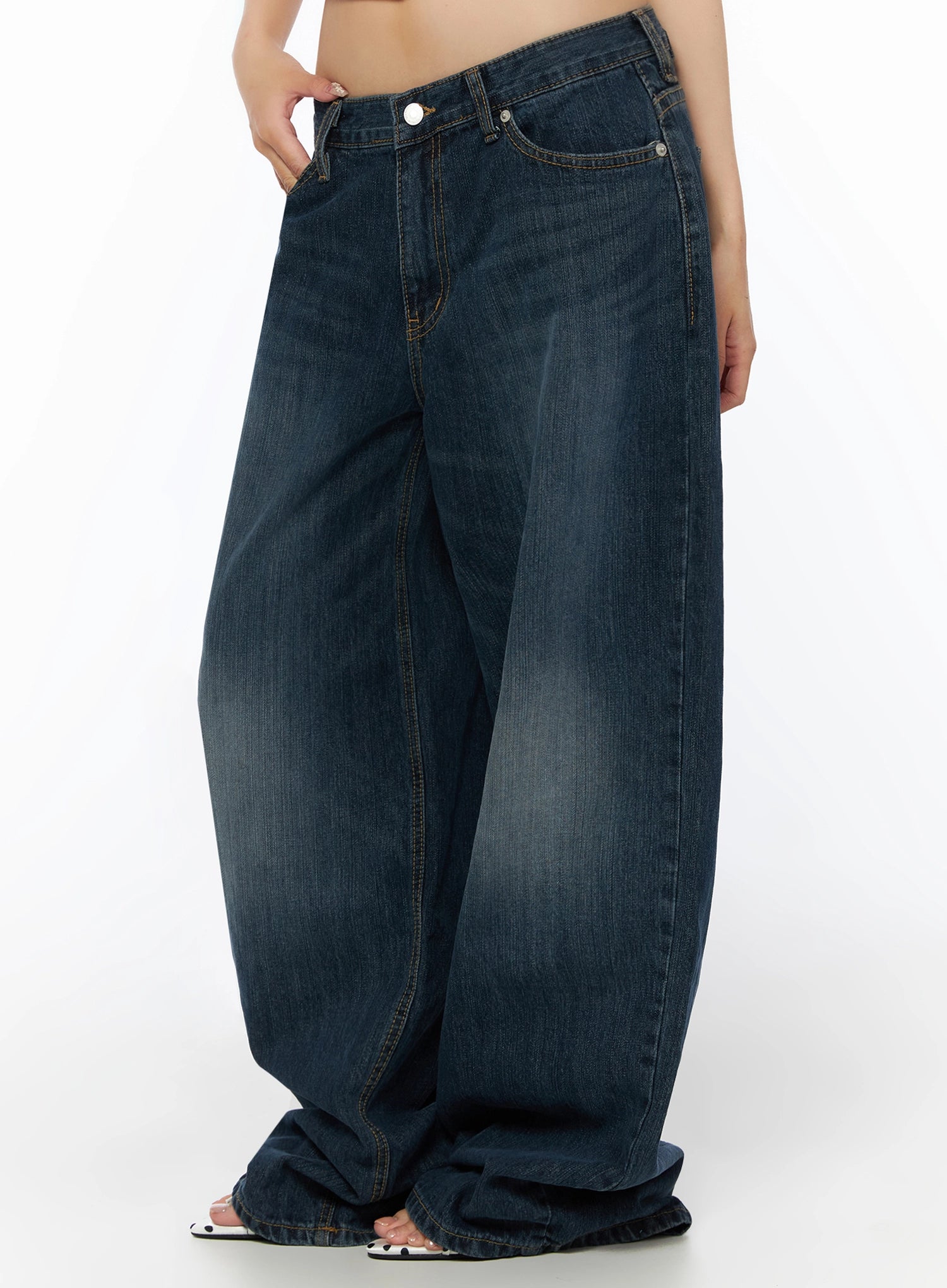Cruz Wide Leg Jeans IL523 Dark blue side close-up from waist down, hand in pocket, balloon-style wide leg with heavy fading and contrast stitching, sandals