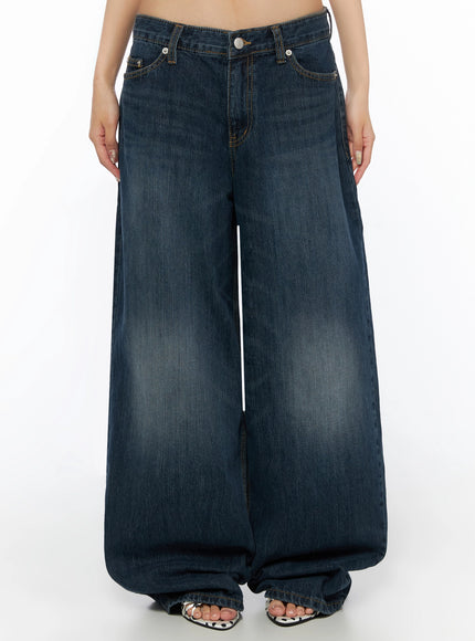 LEWKIN Cruz Wide Leg Jeans IL523 Dark blue front view on model, low-rise waistband with silver button, wide-leg silhouette, washed denim, polka-dot sandals