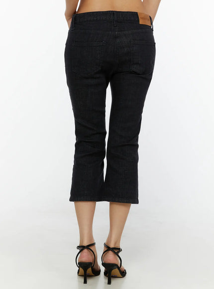 Cyril Low-Rise Capri Jeans CL515 Black back close-up shot on model showing dual back pockets leather patch label and cropped flare hem detail