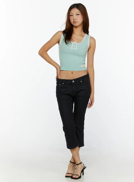 Cyril Low-Rise Capri Jeans CL515 Black full-body front shot on model wearing mint lace-trim crop top and black heeled sandals standing relaxed