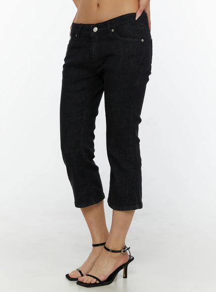 Cyril Low-Rise Capri Jeans CL515 Black close-up front detail shot on model showing low-rise waistband silver button hardware and cropped flare hem