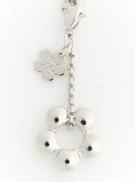 LEWKIN Daisy Petal Necklace IL517 Silver close-up detail of flower bead charm pendant with lobster clasp and engraved clover brand tag
